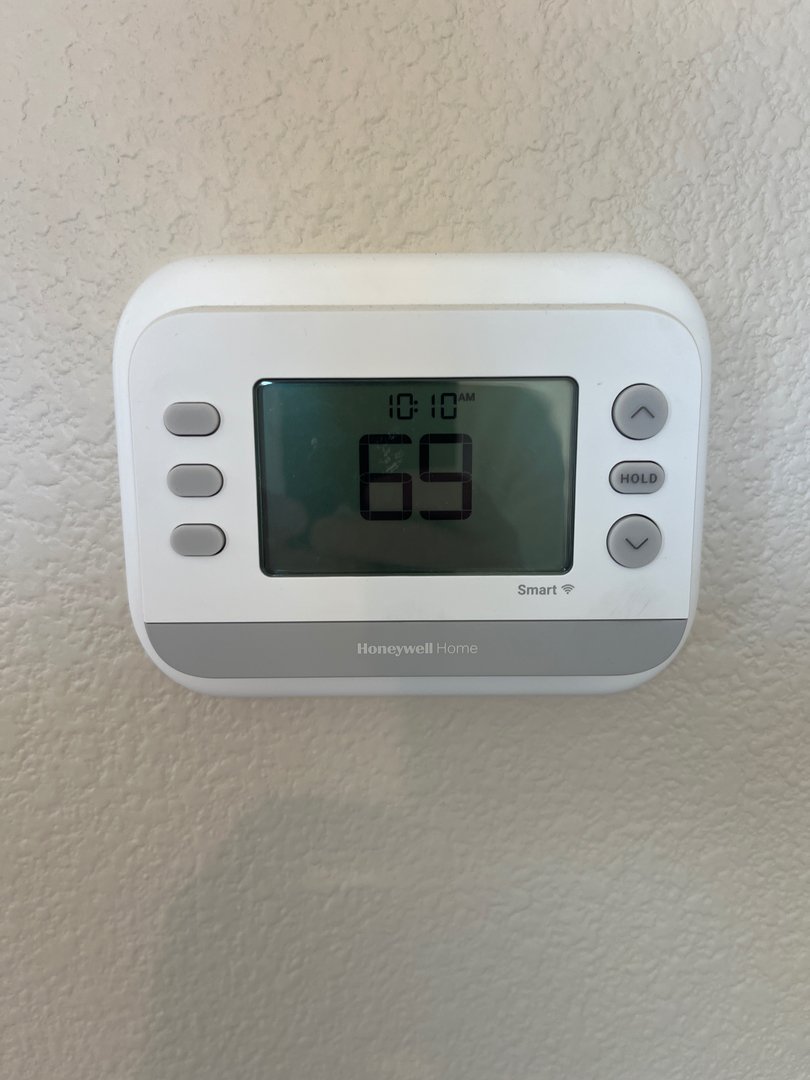 Smart thermostat on a wall, checked as part of an end-of-summer AC maintenance checklist for a Salem home