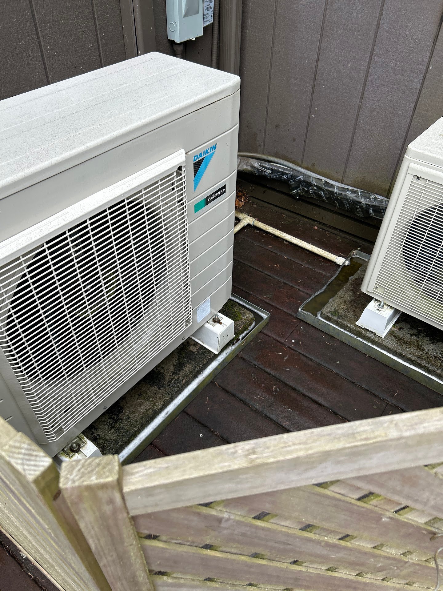 Two outdoor AC condenser units kept clear of debris as part of routine end-of-summer maintenance in Salem