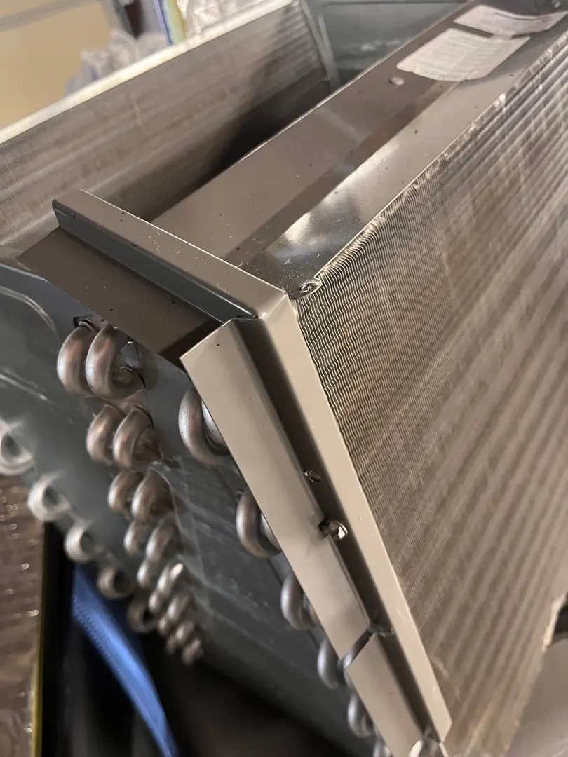 Close-up of an outdoor AC condenser coil during inspection Close-up of an outdoor AC condenser coil during inspection
