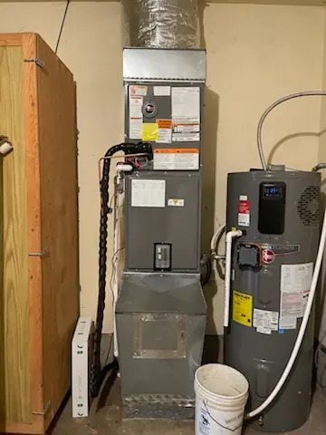 Heat pump air handler and water heater in a utility room Heat pump air handler and water heater in a utility room