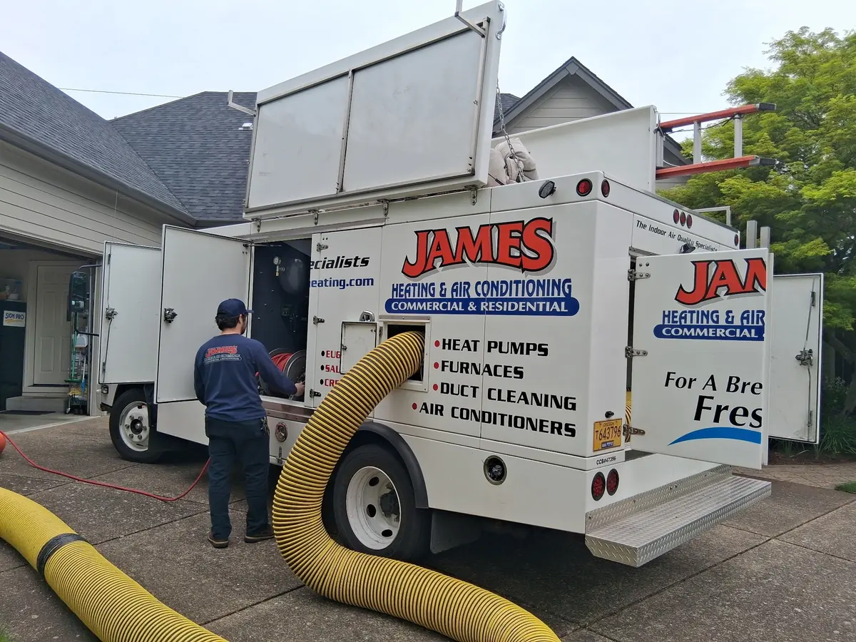 James Heating duct cleaning truck with its vacuum hose run to a house James Heating duct cleaning truck with its vacuum hose run to a house