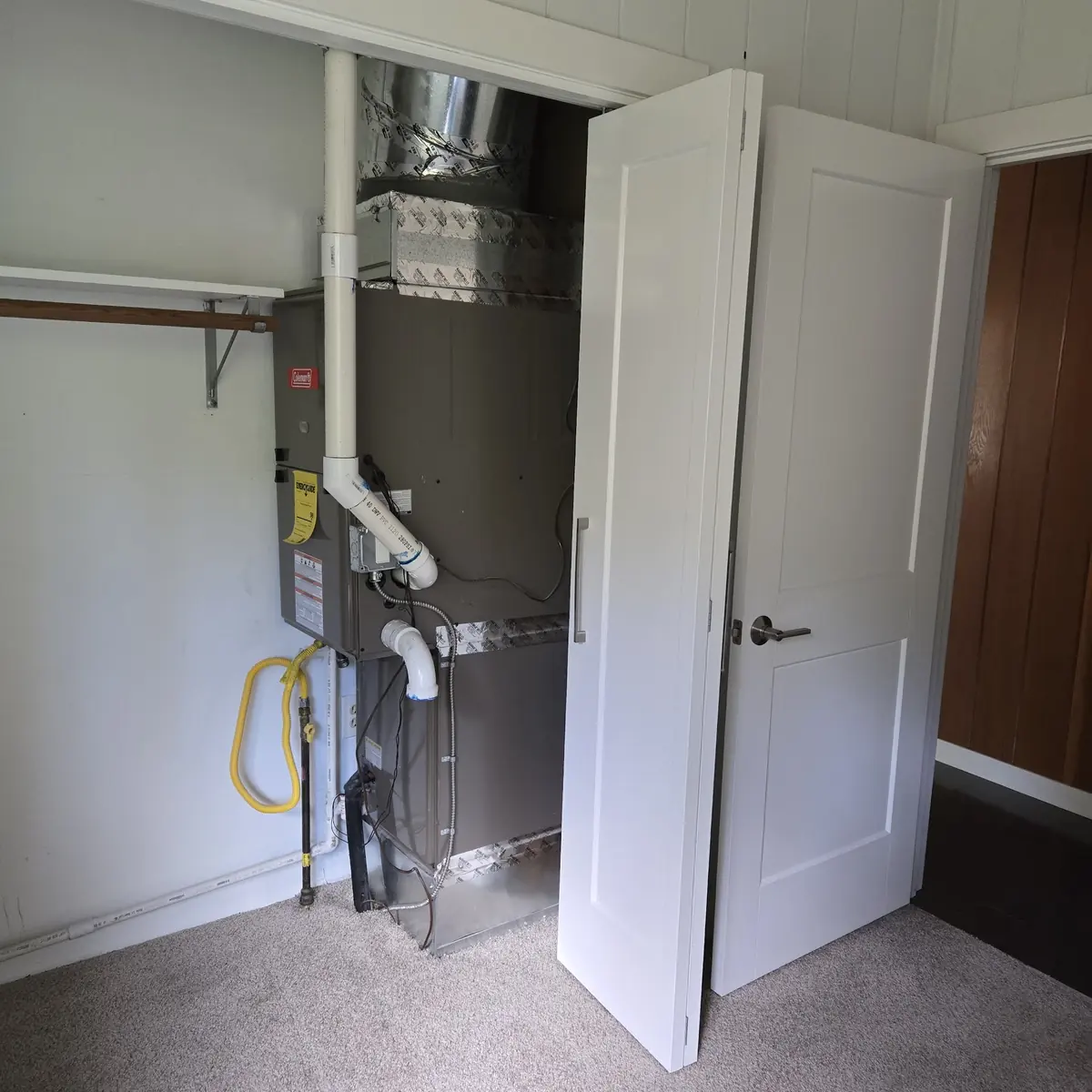 Gas furnace installed in a hallway utility closet Gas furnace installed in a hallway utility closet