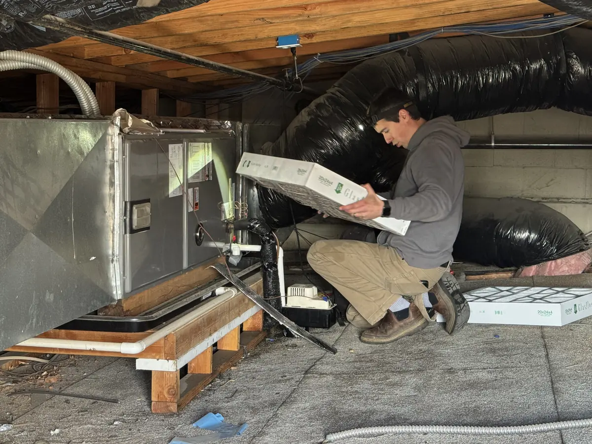 James Heating technician replacing the air filter on an air handler James Heating technician replacing the air filter on an air handler